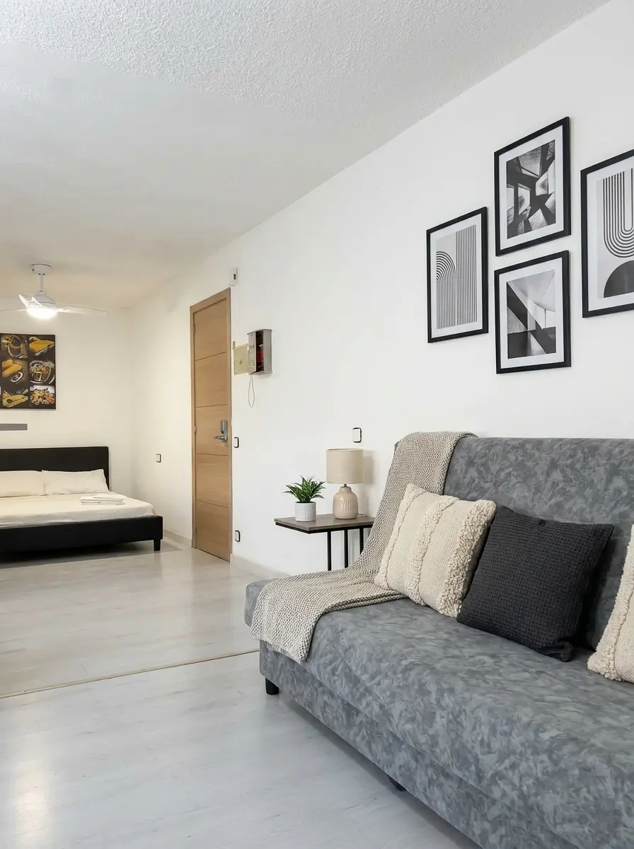 A Sofa Bed By The Window. A Double Bed Across The Room